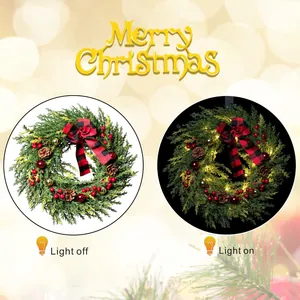 60cm LED Christmas wreath with red berries, pine cones and plaid bow on warm bokeh background