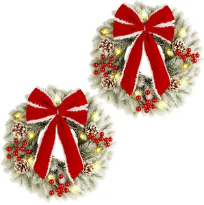 Set of 2 flocked Christmas wreaths with red bows, pine cones, berries and LED lights