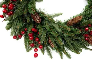 Detaillierte Nahaufnahme von Weihnachtskranz mit grünen Tannennadeln, Beeren und Zapfen