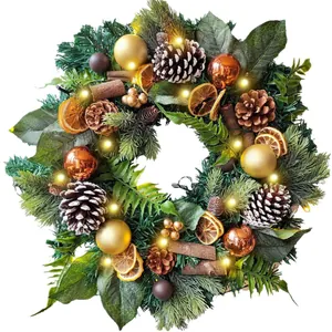 Christmas wreath with LED lights, pine cones, and cinnamon sticks on a white background