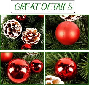 Detailed macro view of artificial pine needles, snow-dusted cones and red Christmas baubles