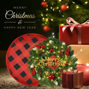 Detail of Christmas wreath with warm LED lights, red berries and plaid buffalo pillow