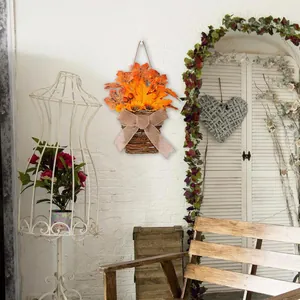 Detail of autumn hanging basket with sunflowers, maple leaves and burlap bow