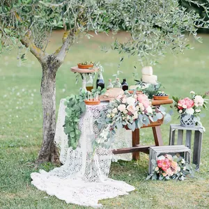 Macro detail of white crochet lace table runner with bohemian floral pattern for wedding decor