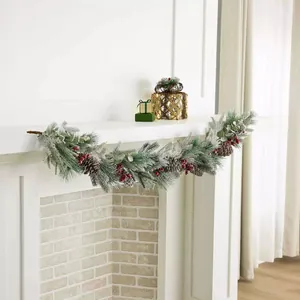 Artificial Christmas garland with frosted pine needles, pine cones, and red berries decor