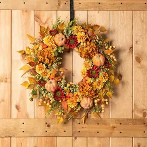 Autumn wreath with sunflowers, pumpkins, and berries on a wooden background for harvest decor