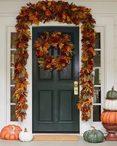 Detailed close-up of autumn harvest wreath with artificial maple leaves and berries