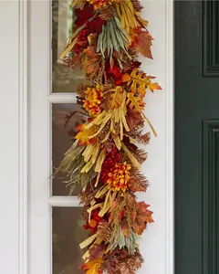 Detailed view of autumn wreath featuring maple leaves, red berries and sunflowers on a white door