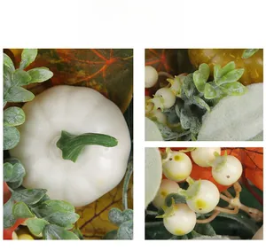 Detail shot of artificial white pumpkin, maple leaves, and autumn berries texture