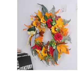 Detail of fall harvest wreath with sunflowers, maple leaves, and checkered bow for door decor