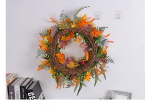 Detail of autumn maple leaf wreath with a striped bow on a natural vine base