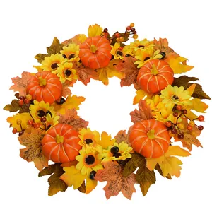 Corona de cosecha otoñal con calabazas, girasoles, hojas de membrillo y bayas rojas