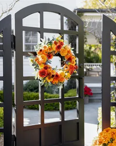 Detailed close-up of autumn door wreath with colorful silk flowers and eucalyptus leaves