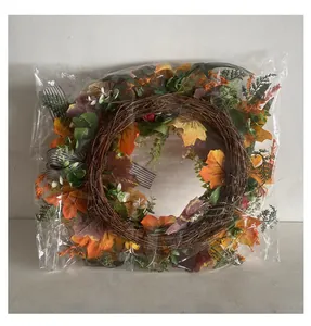Detail of harvest maple leaf wreath with striped ribbon in clear protective packaging