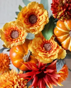 Close-up of artificial dahlias and decorative pumpkins for Thanksgiving wreaths