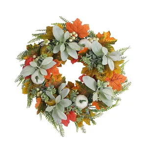 Autumn wreath with maple leaves white pumpkins and berries on a white background