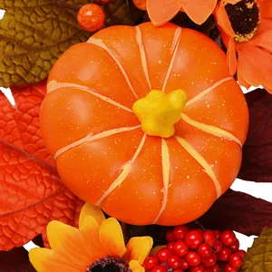 Autumn wreath with orange pumpkin, sunflowers, maple leaves, and red berries for fall decor