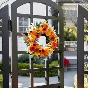 Fall thanksgiving wreath with colorful dahlias, pumpkins and green eucalyptus leaves