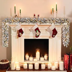 Detail of 9ft flocked Christmas garland with warm LED lights on a white fireplace