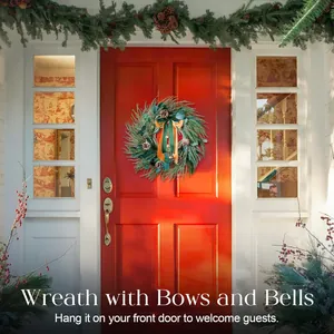 Detail of a 60cm Christmas wreath with pine cones and bells on a red front door