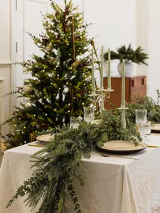 Detailed view of 6ft artificial pine and eucalyptus garland draped on a holiday dining table