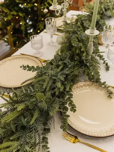 Detail of lush artificial Norfolk pine and eucalyptus garland for Christmas table decor