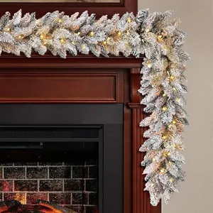 9ft pre-lit flocked Christmas garland with warm LED lights on a wooden fireplace mantle