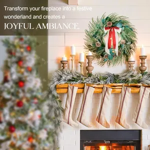 Detail of Christmas wreath with pine cones, golden bells, and ribbons by a cozy fireplace