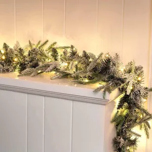 6.3FT flocked Christmas garland with warm LED lights draped on a white mantel