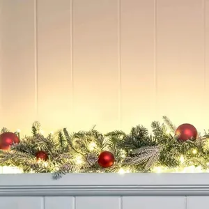 6.3FT flocked Christmas garland with warm LED lights and red baubles on a white mantel