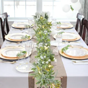 Close-up of 1.8m pre-lit frosted mistletoe garland with warm LED lights for table decor
