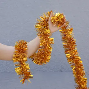 Golden tinsel garland for Christmas and party decoration held to show its fluffy texture