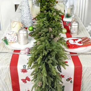 Detail of 6ft Norfolk pine garland with natural pinecones as festive dining table runner