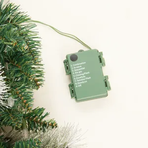 Detail of Christmas garland battery box showing 9 lighting modes on green plastic cover