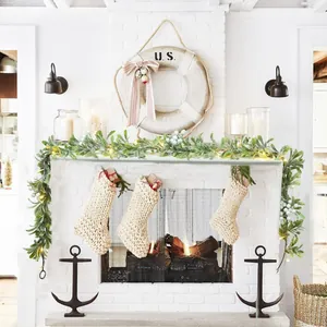 1.8m pre-lit Christmas garland with white berries and cable knit stockings on fireplace