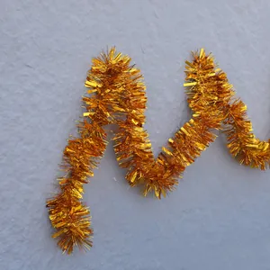 Shiny gold metallic tinsel garland for Christmas tree and festive party wall decoration