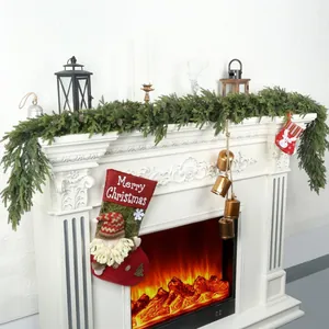6ft Norfolk pine cedar garland with pinecones, red gnome stocking, and bronze bells on mantel