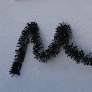 Detailed view of fluffy black tinsel garland with metallic shine for holiday decor