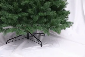 Detail of lush green PE pine needles with a sturdy black four-legged metal stand for stability