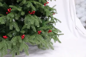 Detail shot of artificial Christmas tree featuring green needles and red berries