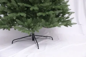 Detailed view of artificial Christmas tree branches with sturdy black metal folding stand base