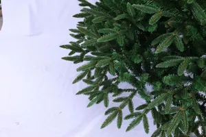 Detailed view of dense dark green PE and PVC needles on a realistic Christmas tree branch