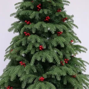 Artificial Christmas tree branch with realistic green needles and vibrant red berries