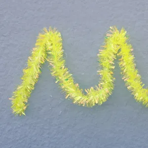 Macro detail of 9cm fluorescent yellow green tinsel garland with a shiny metallic texture