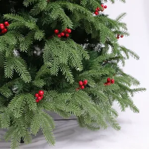 Lush artificial Christmas tree with mixed needles, red berries, and black metal stand
