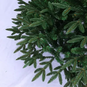 Detailed view of realistic green PE and PVC Christmas tree branches for holiday decor