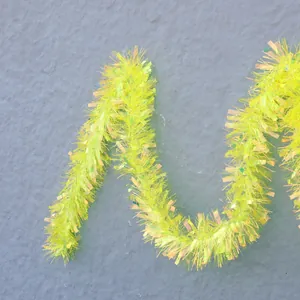 Bright yellow shimmering Christmas tinsel garland for festive party decorations