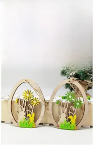 Detail of wooden Easter egg pendants with laser-cut rabbits, felt grass and hemp rope