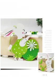Detail view of two Easter bunny ornaments with green ropes and floral egg motifs