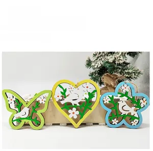 Detailed view of hollow wooden Easter ornaments with floral bird patterns and jute strings